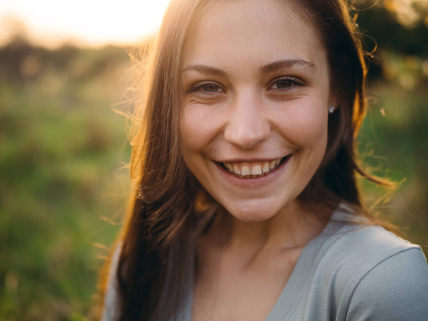 Happy, smiling young girl outdoor.  - Фото, изображение