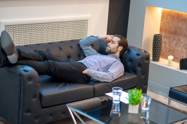 Exhausted businessman resting in his company office - Фото, зображення