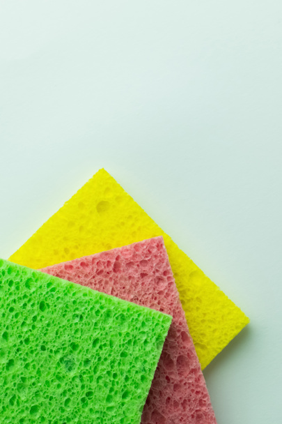 top view of textured colorful sponge cloths on grey background - Fotó, kép