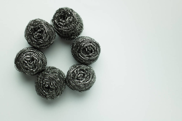 top view of circle made of stainless steel scourers on grey background - Fotografie, Obrázek