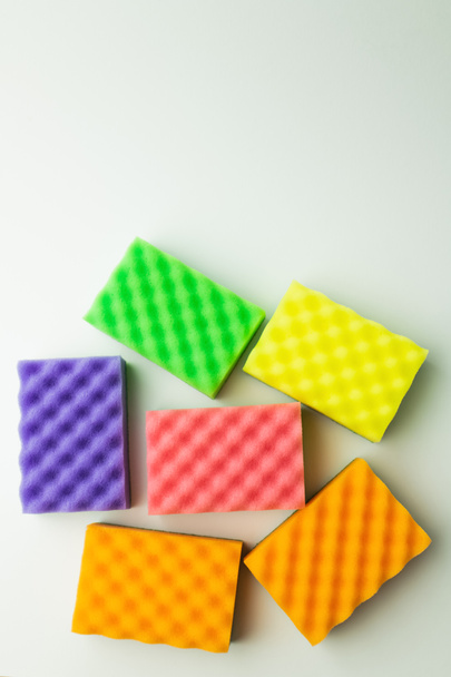 top view of bright multicolored sponges on grey background - Φωτογραφία, εικόνα