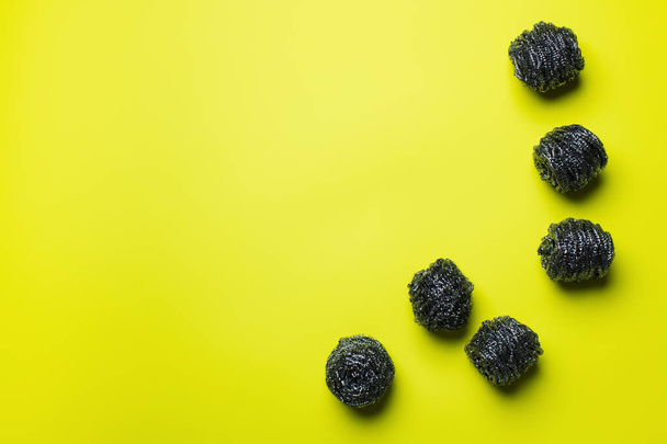 top view of stainless scourers on yellow background with copy space - 写真・画像