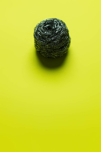 top view of cleansing wire scrubber on yellow background with copy space - Foto, immagini