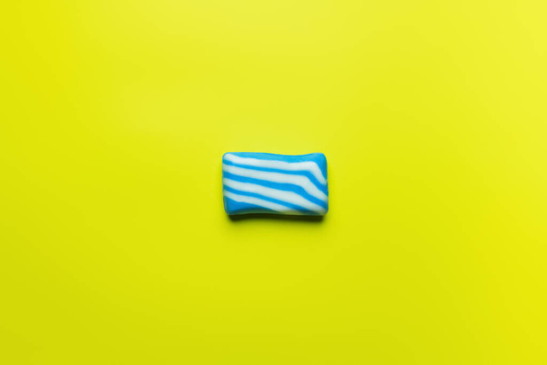 top view of blue and white soap on yellow background with copy space - Zdjęcie, obraz