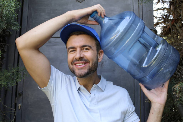 close-up portrait of handsome young man with bottle of water - Photo, image
