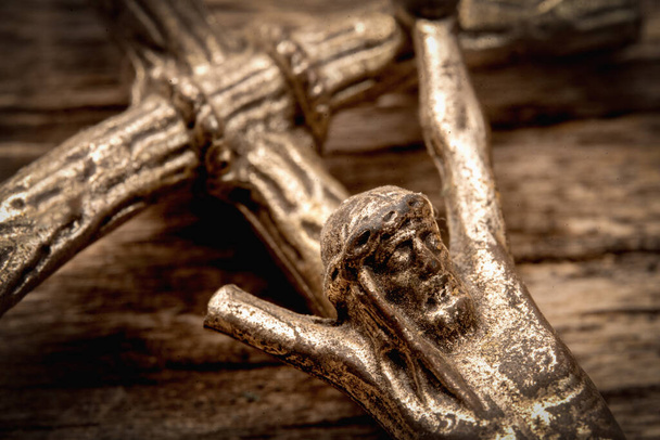 Partially destroyed ancient statue of the crucifixion of Jesus Christ. Close up. Faith, religion, suffering, love, God concept - 写真・画像