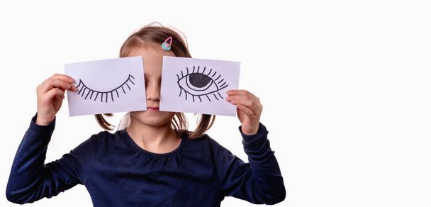  Conceptual portrait of young girl with painted closed and open eyes as symbol of double standards. Copy space. - Photo, Image