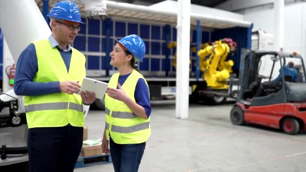 mature man and woman workers of a robotics company engineers - concept of shipping robots logistics - - Video