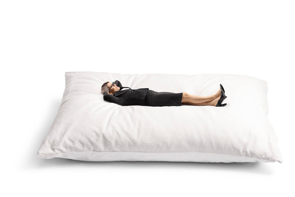 Businesswoman enjoying on a big pillow isolated on white background - Photo, Image
