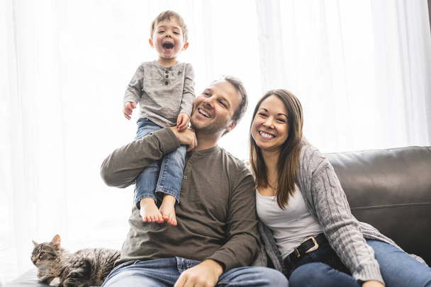 happy family mother and father having fun with child son at home - Foto, imagen