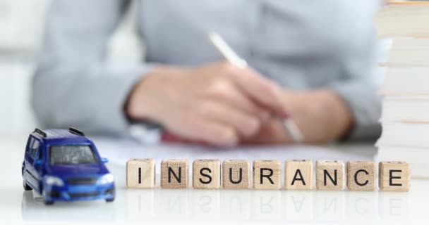 Insurance agent fills out car insurance contract closeup - Video