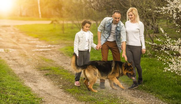 family with a German shepherd dog - Fotoğraf, Görsel