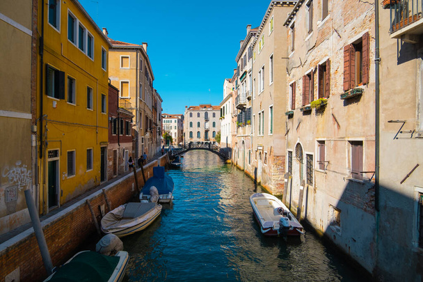 VENICE, ITALY - August 27, 2021: View of empty water streets with a few tourists on the canals of Venice - 写真・画像