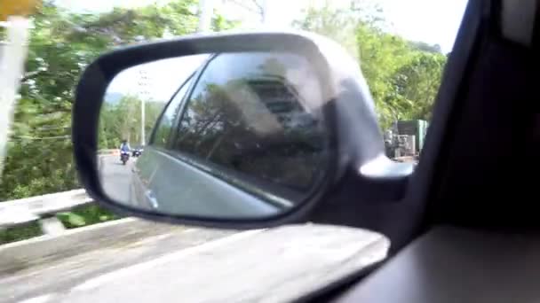 View of the side mirror of car. Left-hand traffic - Video