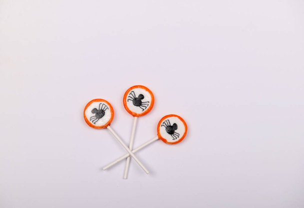 Halloween candy with black spiders isolated on white background - Photo, image