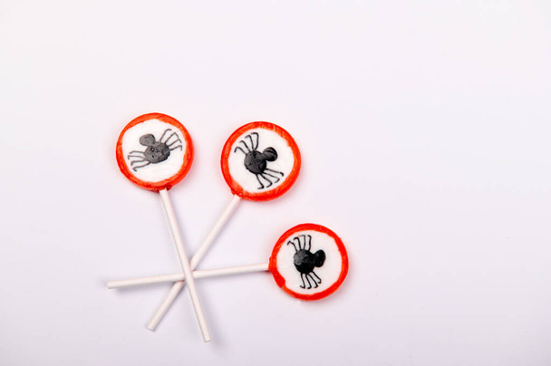 Halloween candy with black spiders isolated on white background - Photo, Image