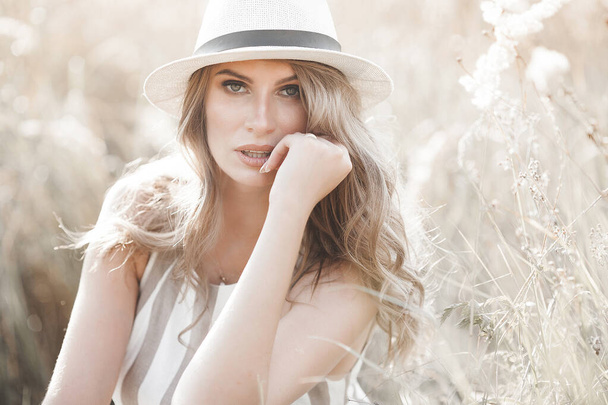 Young attractive woman in the hat. Closeup portrait of beautiful woman outdoors. Pretty lady smiling - Foto, afbeelding