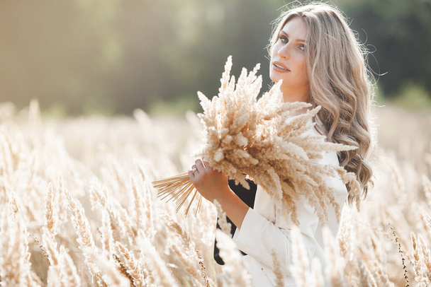 Beautiful blond woman closeup portrait outdoors. Smiling face. Lovely lady at summer background. Emotional female outdoors. - 写真・画像