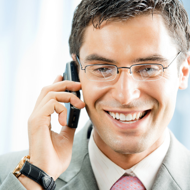 Businessman with phone at office - Photo, image