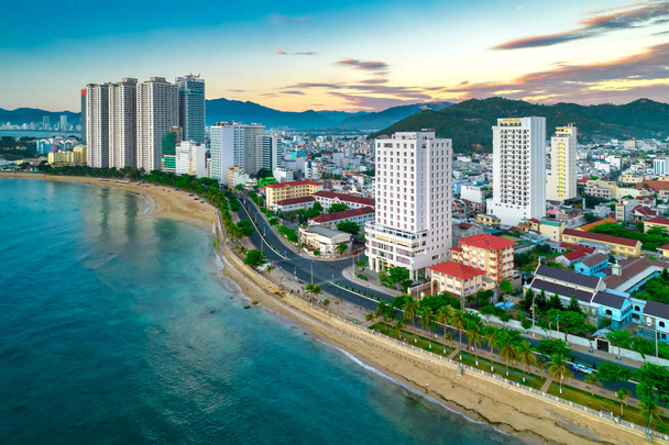 Nha Trang, Vietnam - March 25th, 2022: The coastal city of Nha Trang seen from above in the afternoon with its beautiful city and clean sandy beach attracts tourists to visit in Nha Trang, Vietnam - Fotoğraf, Görsel