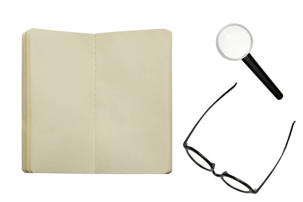 open blank notebook with glasses and magnifyglass or hand lens - Photo, Image