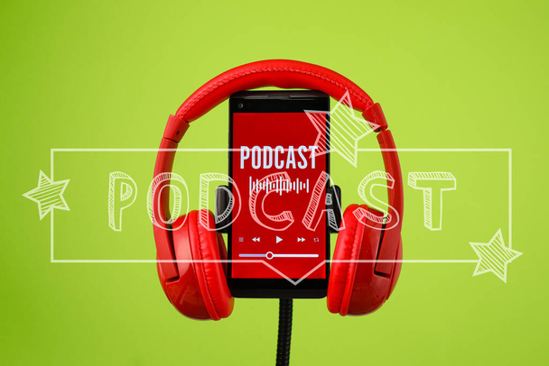 Modern headphones and mobile phone with podcast playlist on screen against green background - Fotoğraf, Görsel