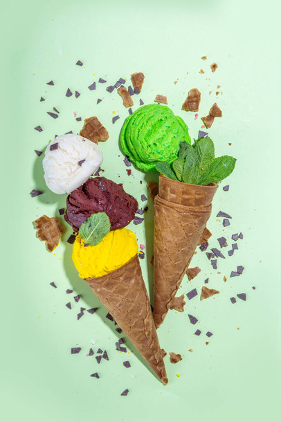 Collection of bright ice cream in waffle cones, Set of various flavor ice cream on colorful background flatlay copy space - Foto, Bild