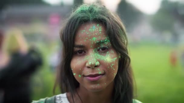 Close up of multiracial woman looking at camera at holi festival. Shot with RED helium camera in 8K.  - Záběry, video
