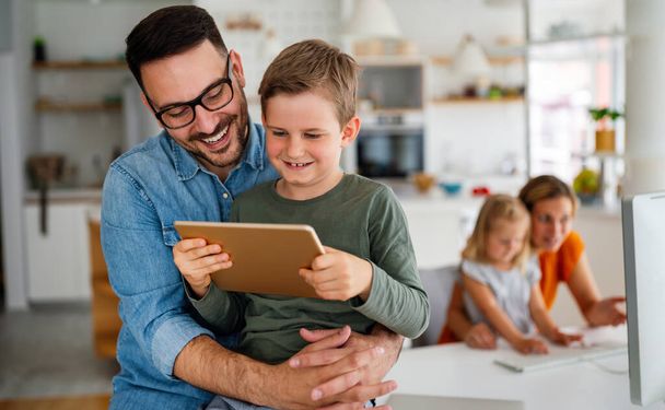 Distance learning, online education, home work schooling concept. Happy family with digital devices at home. - Fotoğraf, Görsel