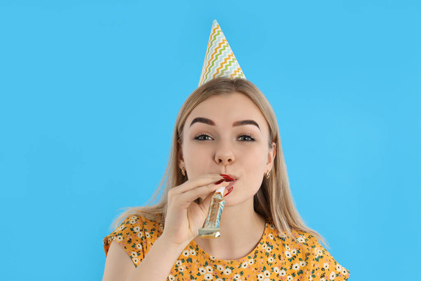 Concept of Happy Birthday, young woman on blue background - Foto, afbeelding