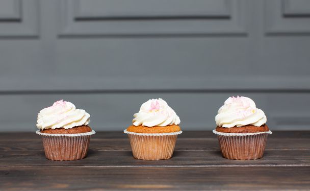 Cupcakes stand on a wooden board - Photo, image