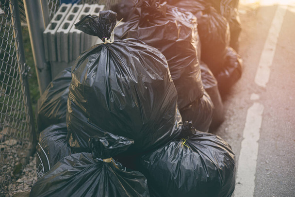 Pile of black Garbage bags. City waste management good hygiene. - Foto, imagen