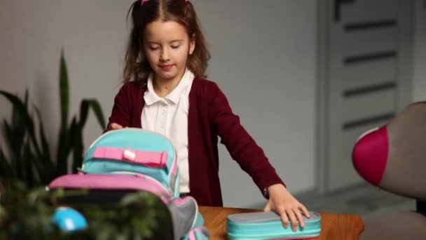 Schoolgirl put books and notes into backpack at home, pupil prepare staff for education, School supplies, Back to school concept. - Footage, Video