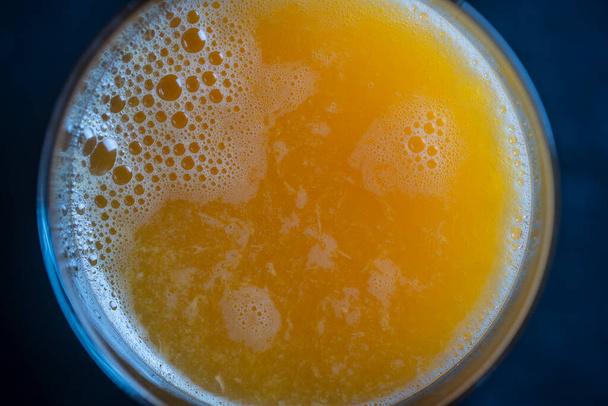 Glass of fresh orange juice, close up, top view. Freshly squeezed citrus juice. Refreshing morning drink - Zdjęcie, obraz