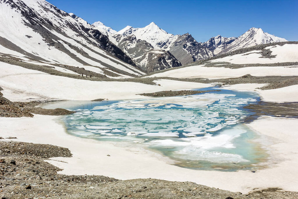 The turquoise frozen lake on top of the high altitude pass of Shingo La in the Great Himalayan range on the trek from Lahaul to Zanskar in North India. - Foto, immagini
