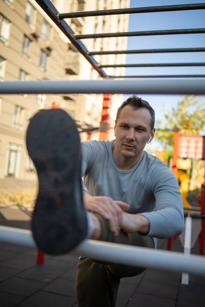 A man is engaged in sports outside on the playground, fitness, sport, lifestyle. - Fotografie, Obrázek