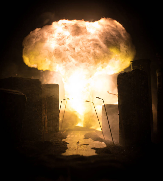 Nuclear war apocalypse concept. Explosion of nuclear bomb in city. City destroyed by atomic war. Creative artwork decoration in dark. Selective focus - Photo, Image