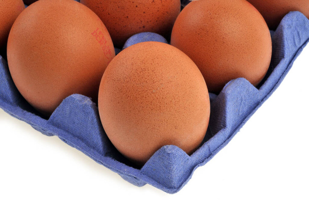 Chicken eggs in their packaging close-up on a white background - Foto, imagen