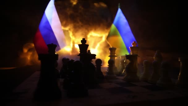 Concept of war or manipulation with global politics. War between Russia and Ukraine, conceptual image of war using chess board and national flags on the background of explosion. - Кадры, видео