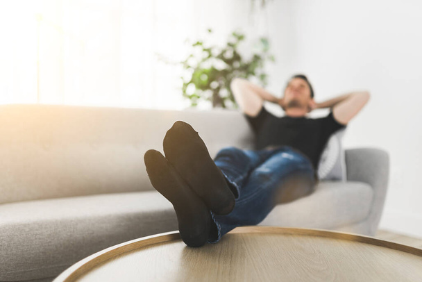 Relaxing man and dreaming on sofa at home - Foto, Bild