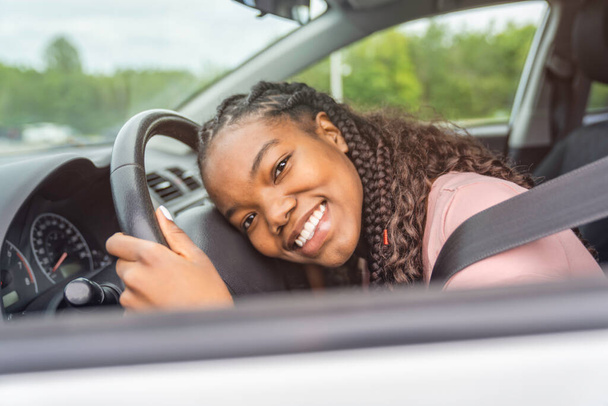 Young black teenage driver seated in her new car - Fotoğraf, Görsel