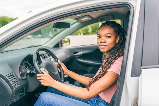 Young black teenage driver seated in her new car - Fotoğraf, Görsel