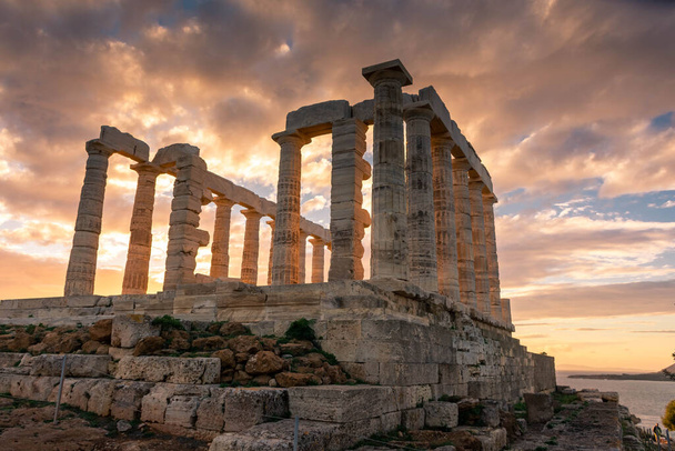 The Temple of Poseidon at Cape Sounion at sunset, over the Aegean Sea in Greece - Фото, изображение