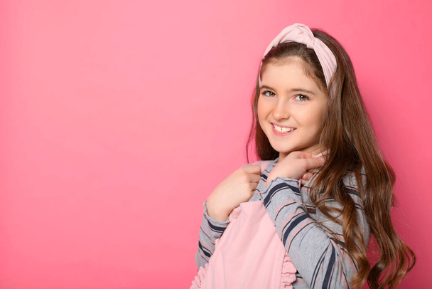 cute child with dungarees over pink background on studio - Foto, immagini