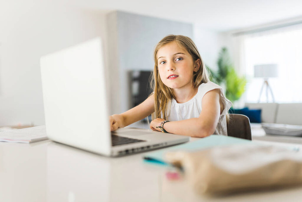 Pretty little girl enjoys learning and doing some homework - Photo, Image