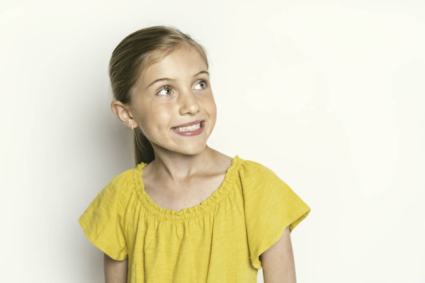 stylish little girl portrait in the studio white background - Photo, Image