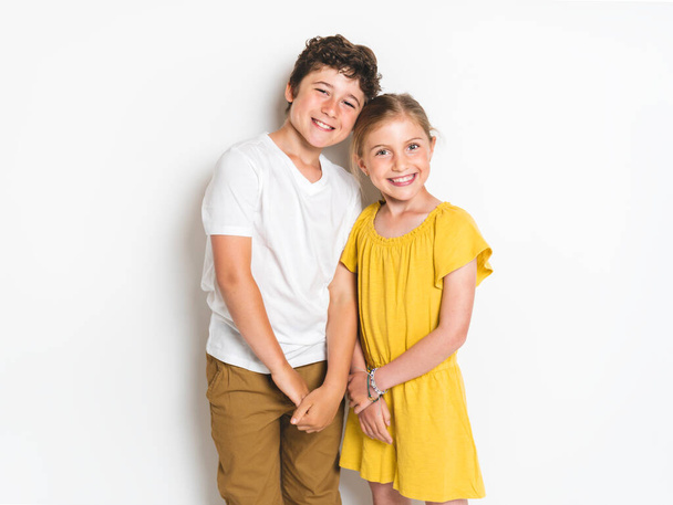 Portrait of cute girl and boy on studio white background - Photo, image