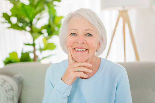 portrait of elderly woman sit on the sofa at home - Fotoğraf, Görsel
