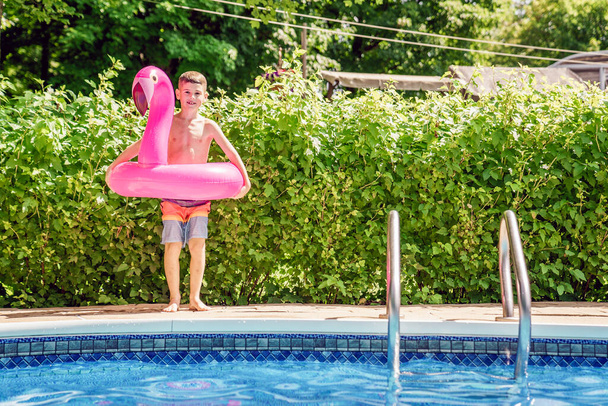 kid having fun on in a swimming pool. - Photo, Image