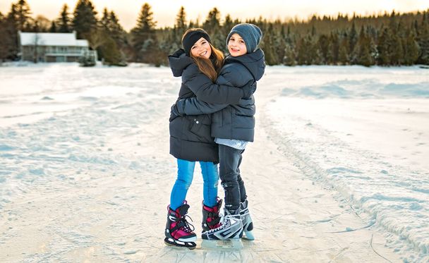 brother and sister child in thermal suits skating outdoors - Photo, image